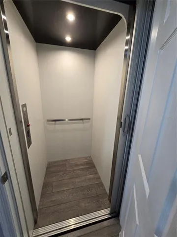 a view of a hallway with seating area