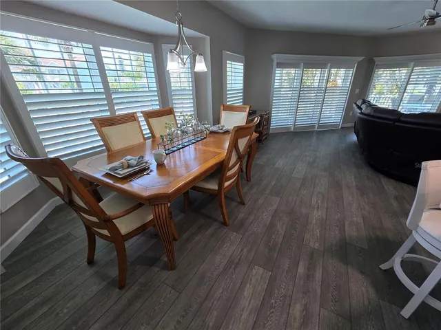 a dining room with furniture and wooden floor