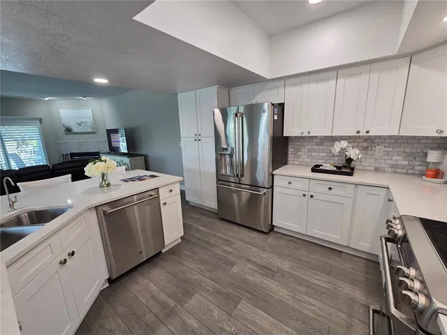 a kitchen with a sink cabinets and stainless steel appliances