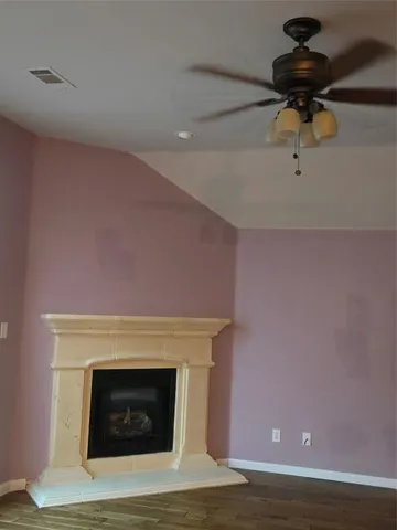 a room with fireplace and wooden floor