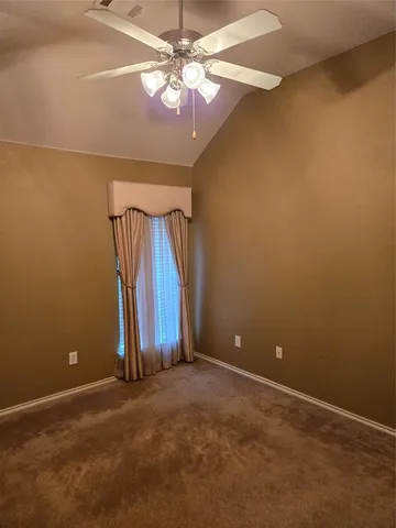 a view of an empty room with a fan