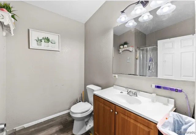 a bathroom with a sink vanity mirror and toilet