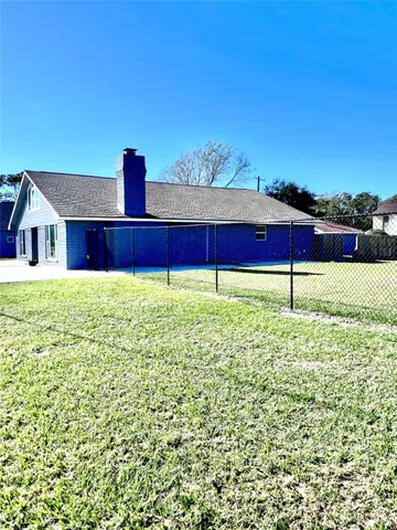 a view of an house with backyard space and balcony