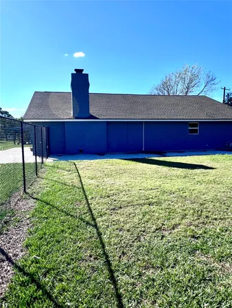 a view of a yard with a house in the background