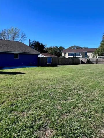a view of a yard with a house in the background