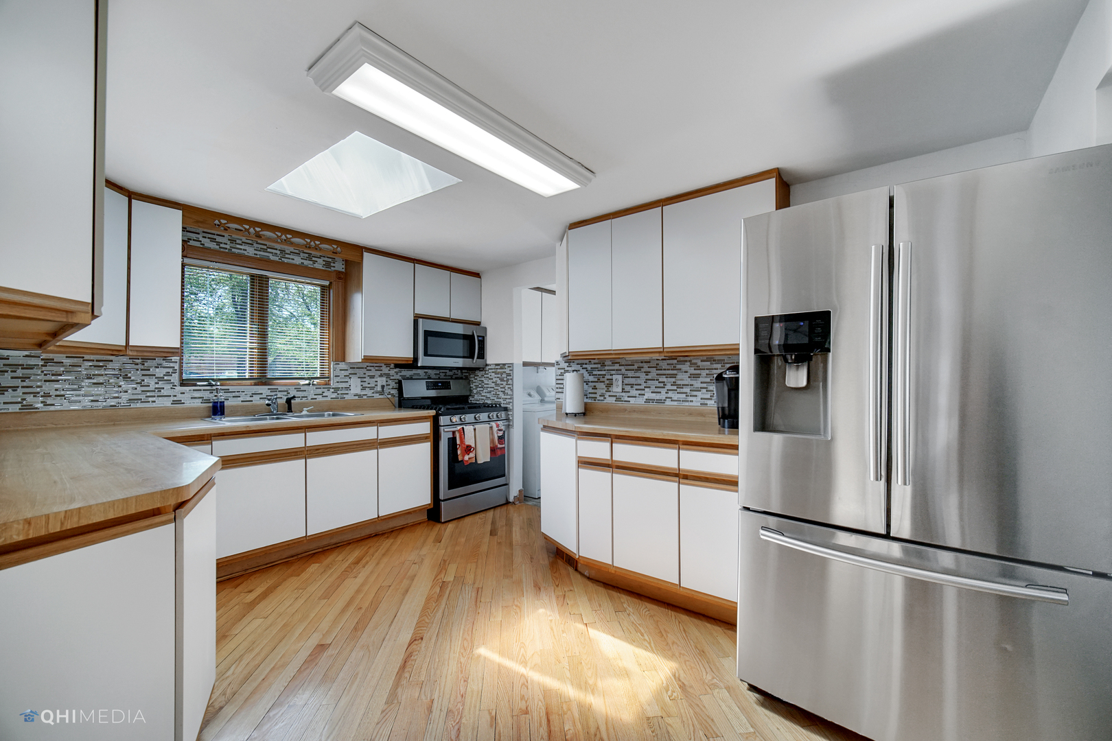 222 Thornhurst Road Bolingbrook, IL 60440 - Photo 6 of 22 a kitchen with stainless steel appliances granite countertop a refrigerator a stove a sink and white cabinets with wooden floor