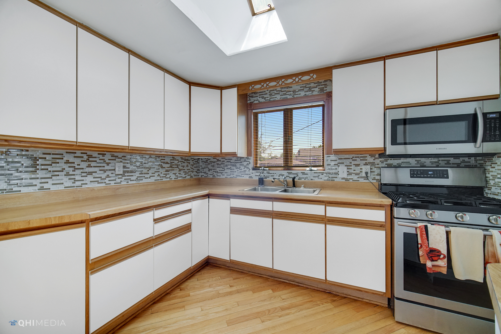 222 Thornhurst Road Bolingbrook, IL 60440 - Photo 7 of 22 a kitchen with stainless steel appliances granite countertop a sink stove and microwave