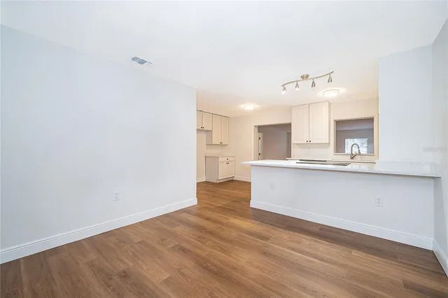 a view of kitchen with wooden floor and window