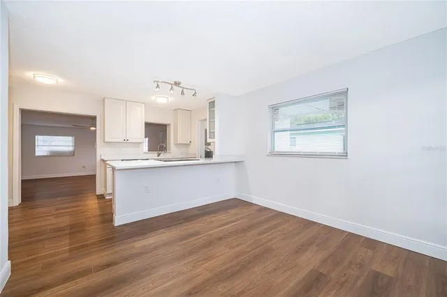 a view of kitchen with granite countertop cabinets and wooden floor