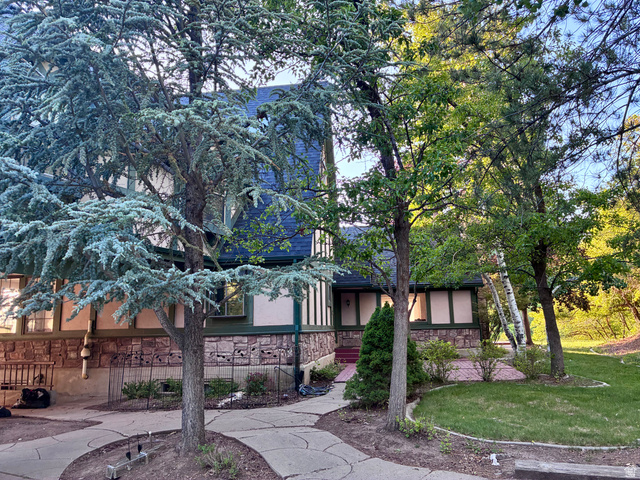 1903 Ridgehollow Drive Bountiful, UT 84010 - Photo 18 of 24 Multi-story exterior with a stone and stucco facade, complemented by a dark blue roof