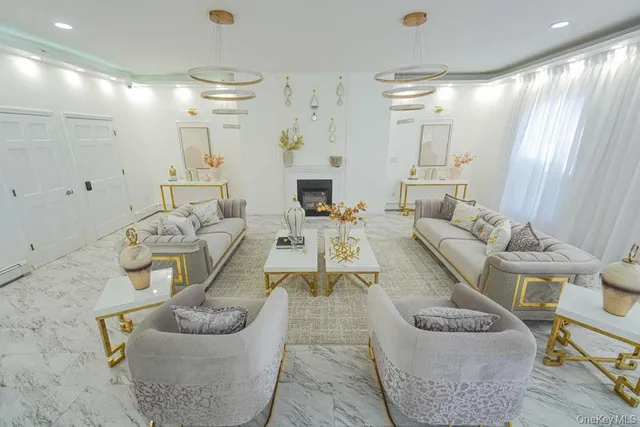 a living room with furniture and a chandelier