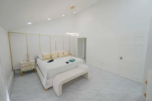 a spacious bedroom with a bed and a table