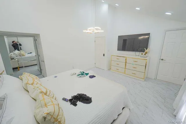 a bedroom with a bed and a flat screen tv