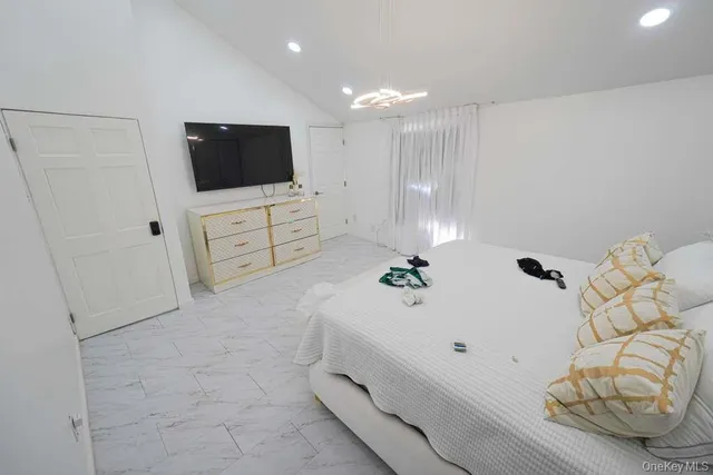 a bathroom with a bathtub and television