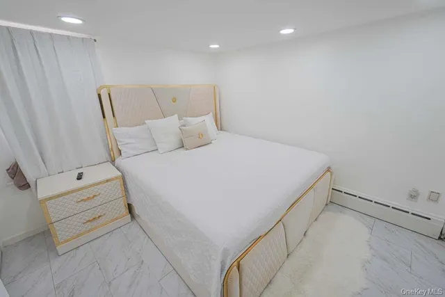 a bed room with a bed and a night stand