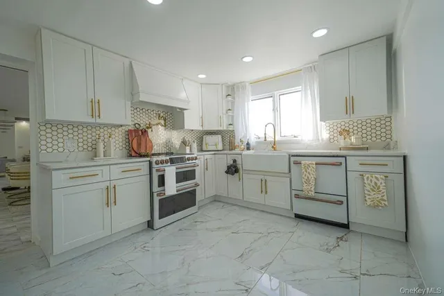 a kitchen with a stove sink and cabinets
