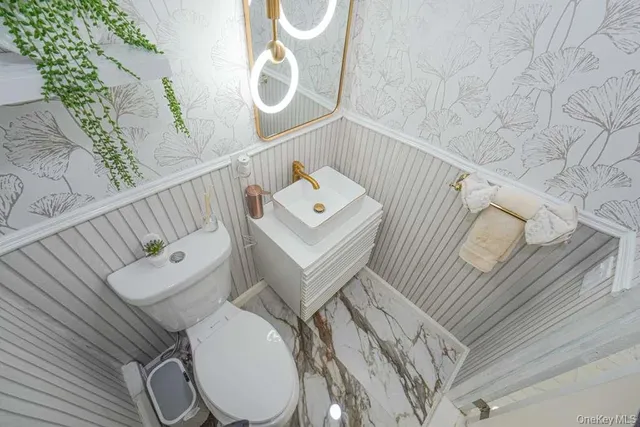 a white toilet sitting next to a shower