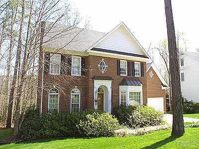8008 Tylerton Drive Raleigh, NC 27613 - Photo 1 of 1 a front view of a house with garden