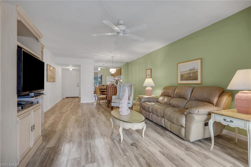1025 Foxfire Lane, Unit 110 Naples, FL 34104 - Photo 11 of 48 a living room with furniture and a flat screen tv