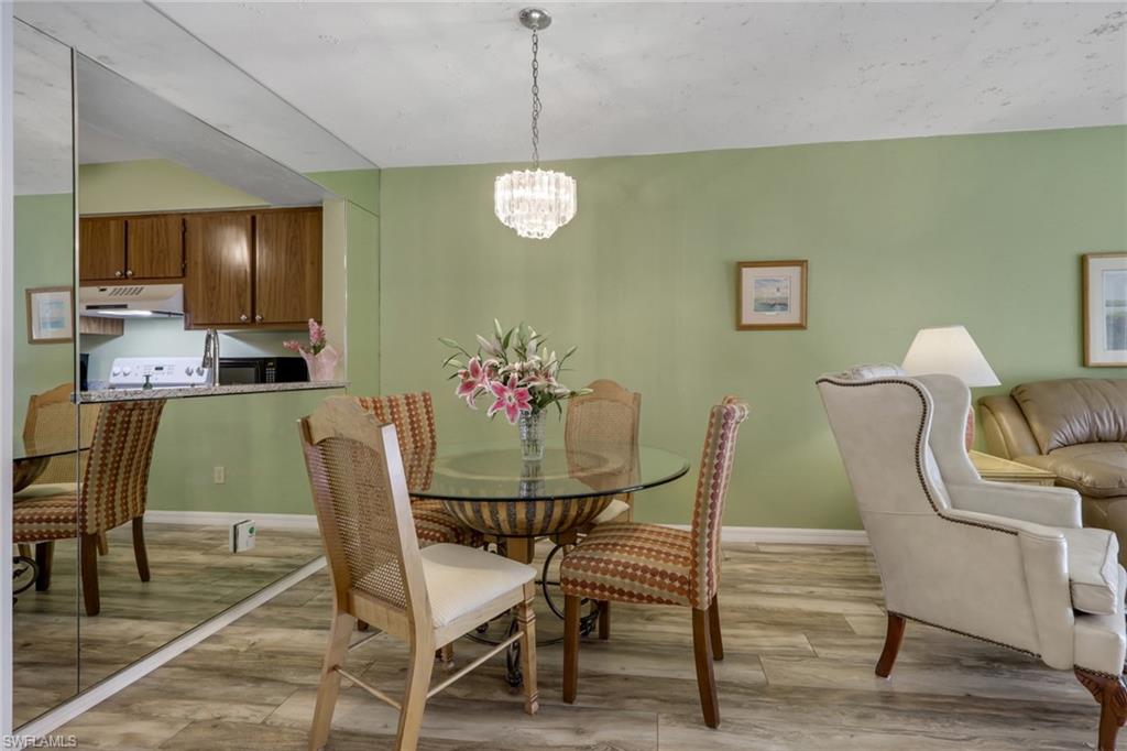 1025 Foxfire Lane, Unit 110 Naples, FL 34104 - Photo 16 of 48 a dining room with furniture and window