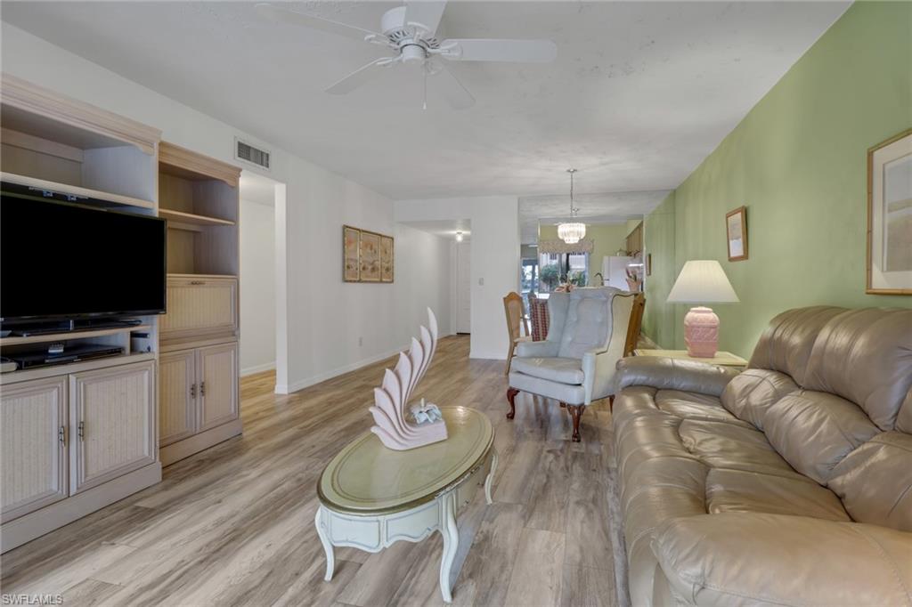 1025 Foxfire Lane, Unit 110 Naples, FL 34104 - Photo 18 of 48 a living room with furniture and a flat screen tv