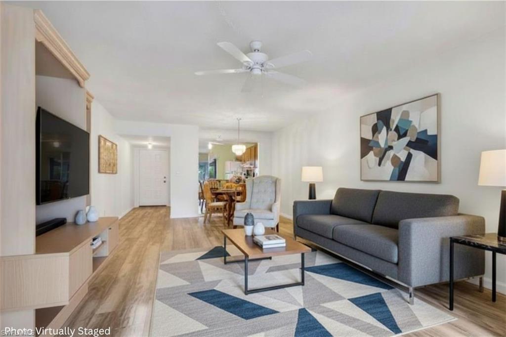 1025 Foxfire Lane, Unit 110 Naples, FL 34104 - Photo 2 of 48 a living room with furniture and a flat screen tv