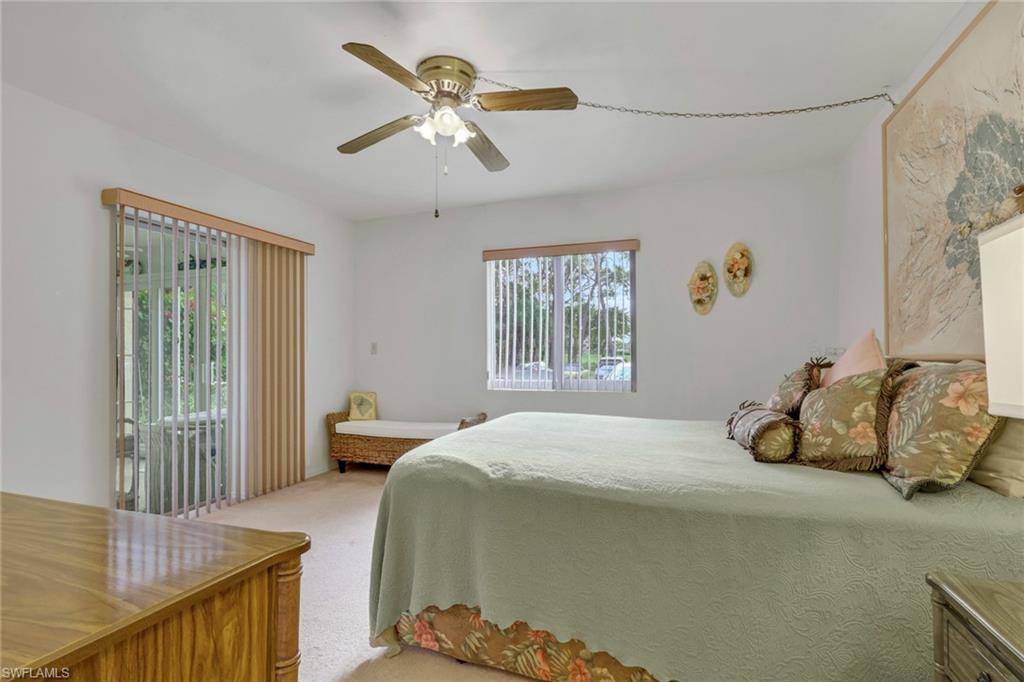 1025 Foxfire Lane, Unit 110 Naples, FL 34104 - Photo 21 of 48 a bedroom with a bed and a window