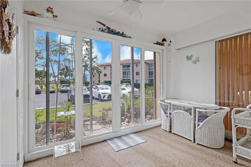 1025 Foxfire Lane, Unit 110 Naples, FL 34104 - Photo 27 of 48 a view of a porch with furniture and backyard
