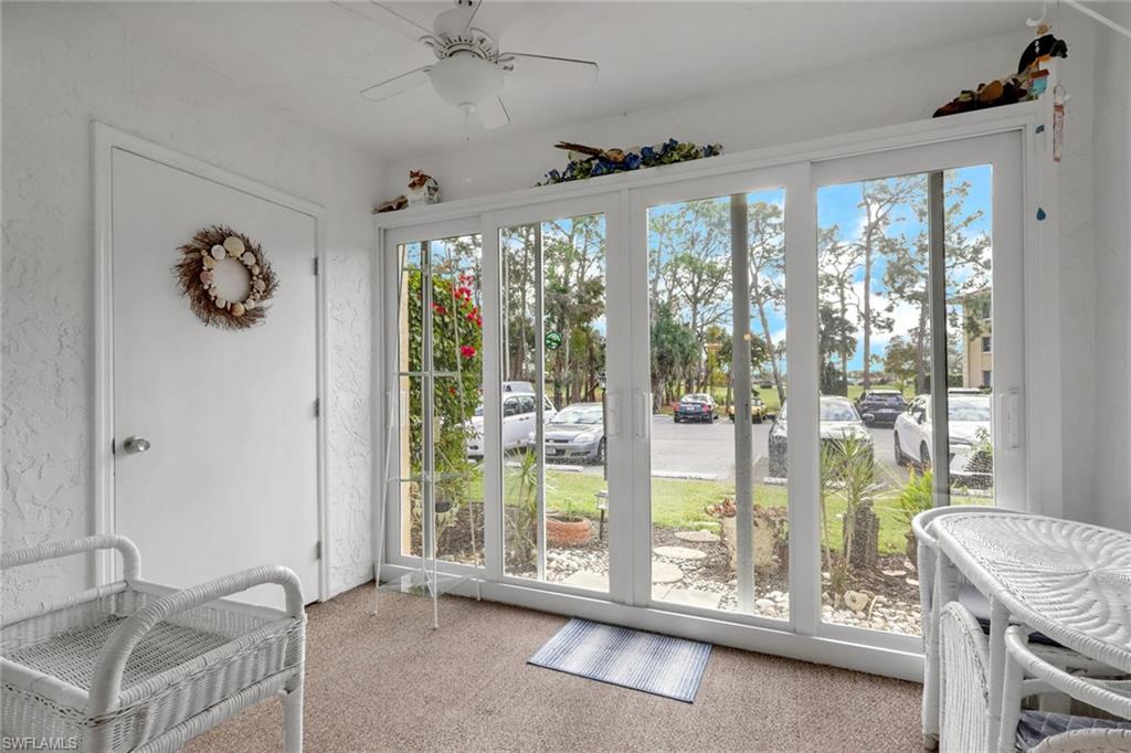 1025 Foxfire Lane, Unit 110 Naples, FL 34104 - Photo 28 of 48 a living room with a large window