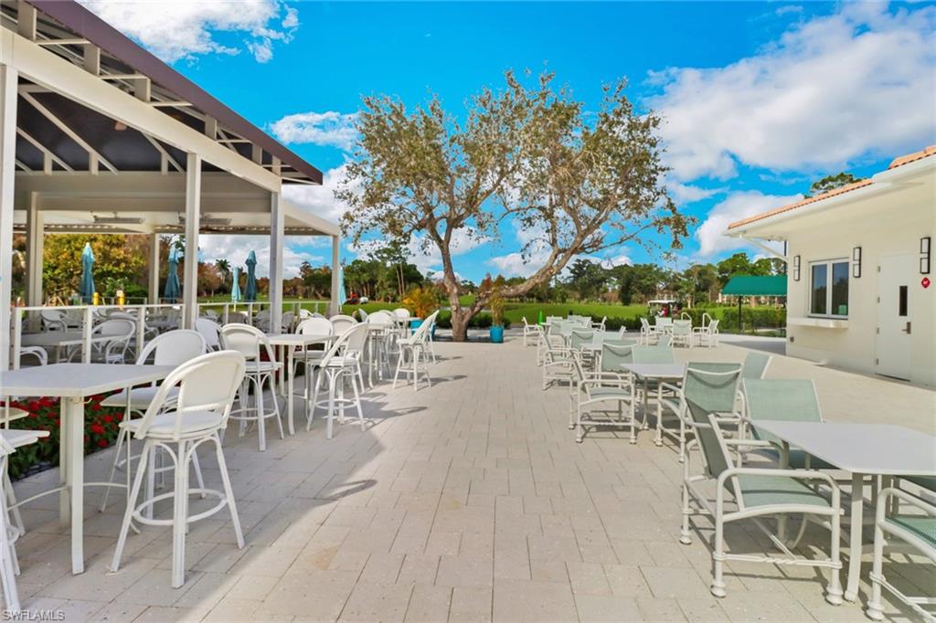1025 Foxfire Lane, Unit 110 Naples, FL 34104 - Photo 37 of 48 a view of a patio with table and chairs and potted plants