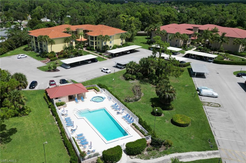 1025 Foxfire Lane, Unit 110 Naples, FL 34104 - Photo 48 of 48 an aerial view of an house swimming pool patio and outdoor seating