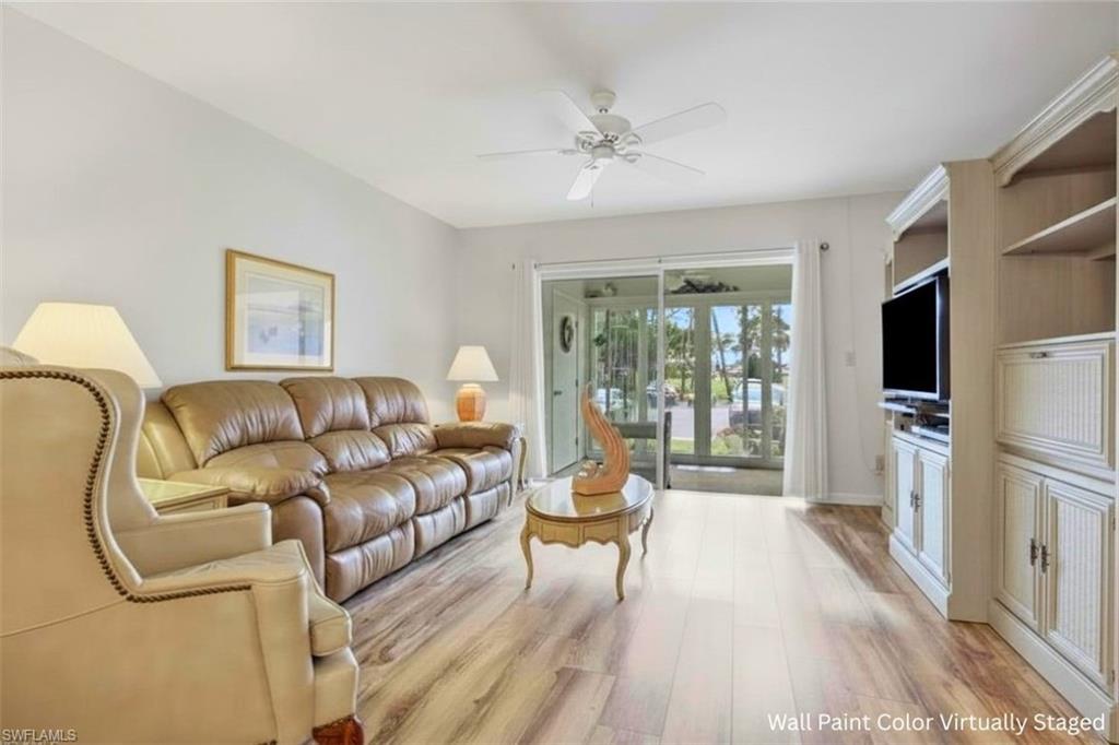 1025 Foxfire Lane, Unit 110 Naples, FL 34104 - Photo 6 of 48 a living room with furniture and a flat screen tv