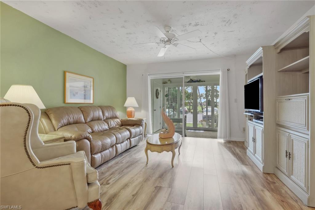 1025 Foxfire Lane, Unit 110 Naples, FL 34104 - Photo 7 of 48 a living room with furniture and a flat screen tv