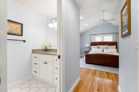 a bedroom with a large bed and a chandelier