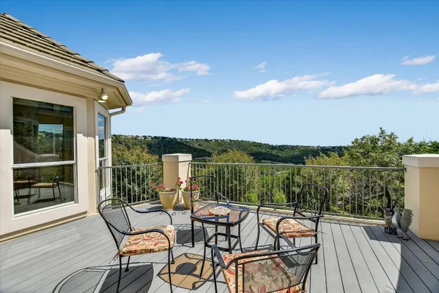 a view of a chair and table in the balcony
