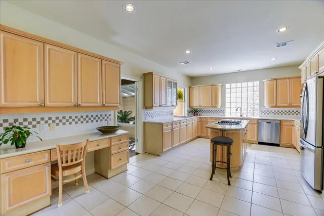 a kitchen with a sink and chairs