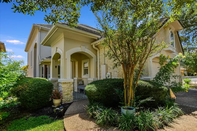 a front view of a house with garden