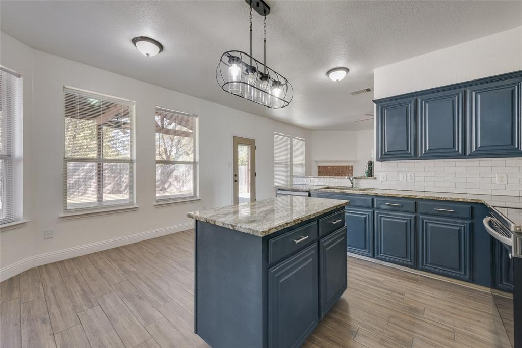 2701 Wildridge Court Fort Worth, TX 76108 - Photo 11 of 26 a kitchen with stainless steel appliances granite countertop a sink a stove and a wooden floors