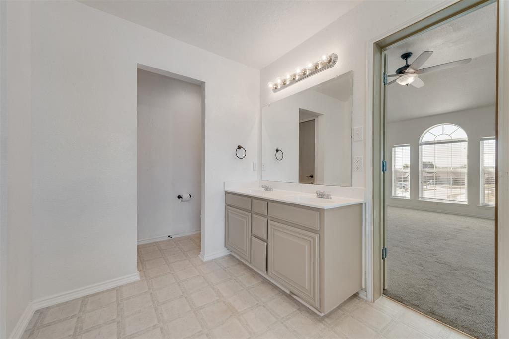 2701 Wildridge Court Fort Worth, TX 76108 - Photo 14 of 26 a bathroom with a double vanity sink mirror and shower