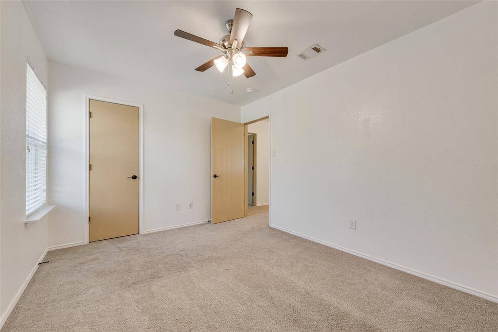 2701 Wildridge Court Fort Worth, TX 76108 - Photo 19 of 26 an empty room with a ceiling fan and a window