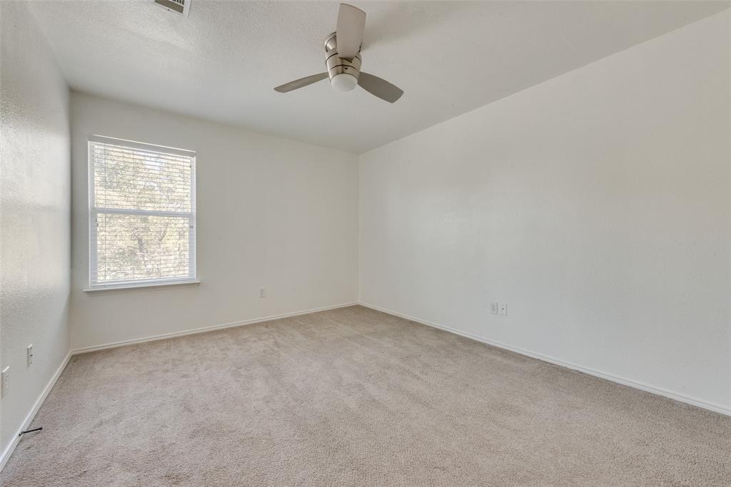 2701 Wildridge Court Fort Worth, TX 76108 - Photo 20 of 26 an empty room with windows