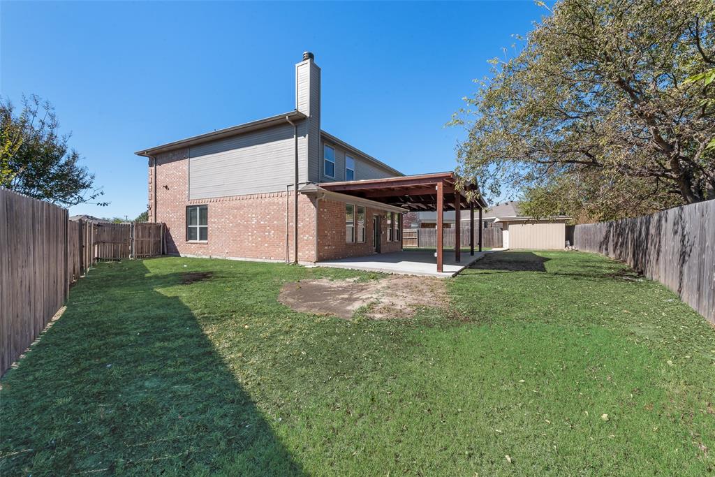 2701 Wildridge Court Fort Worth, TX 76108 - Photo 25 of 26 a view of a house with a yard and fence