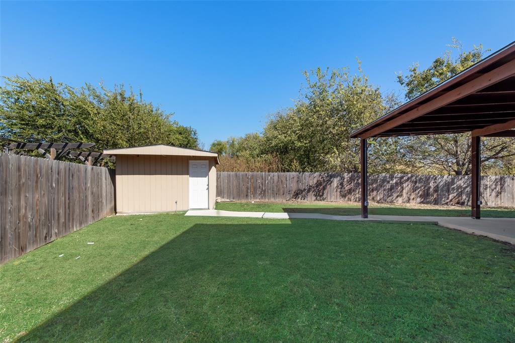 2701 Wildridge Court Fort Worth, TX 76108 - Photo 26 of 26 a view of a backyard with a small cabin