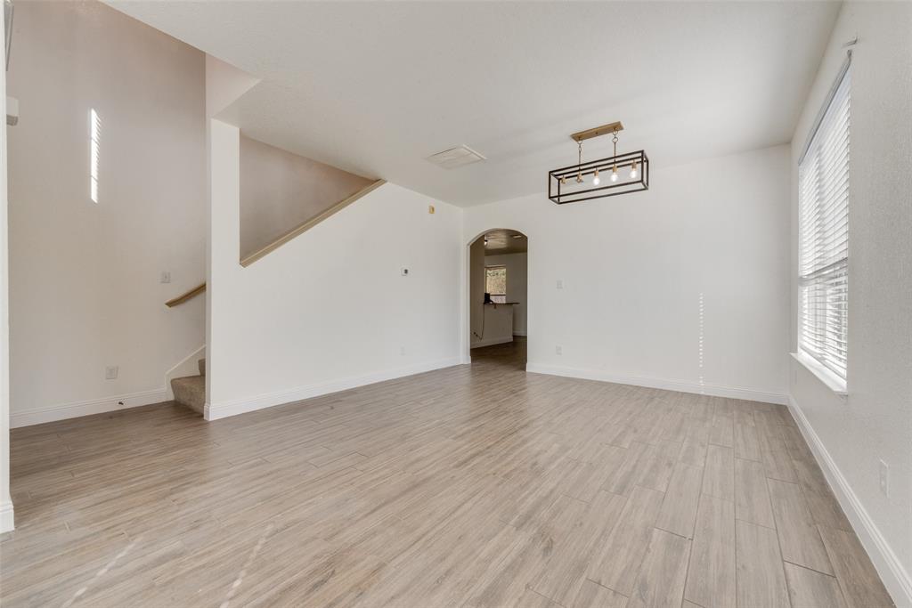 2701 Wildridge Court Fort Worth, TX 76108 - Photo 5 of 26 an empty room with wooden floor and windows