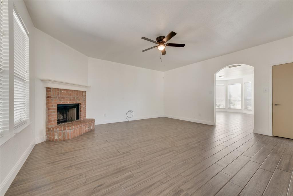 2701 Wildridge Court Fort Worth, TX 76108 - Photo 6 of 26 a view of an empty room with a fireplace and a window