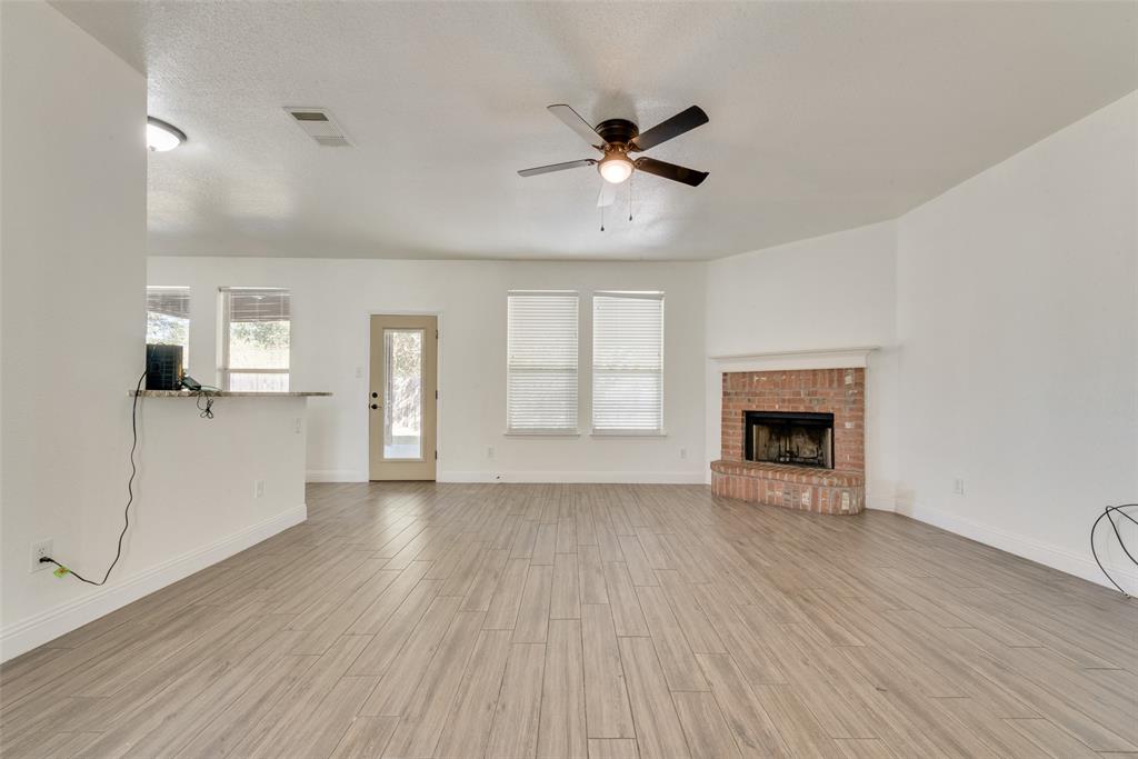2701 Wildridge Court Fort Worth, TX 76108 - Photo 7 of 26 a view of empty room with wooden floor and fan