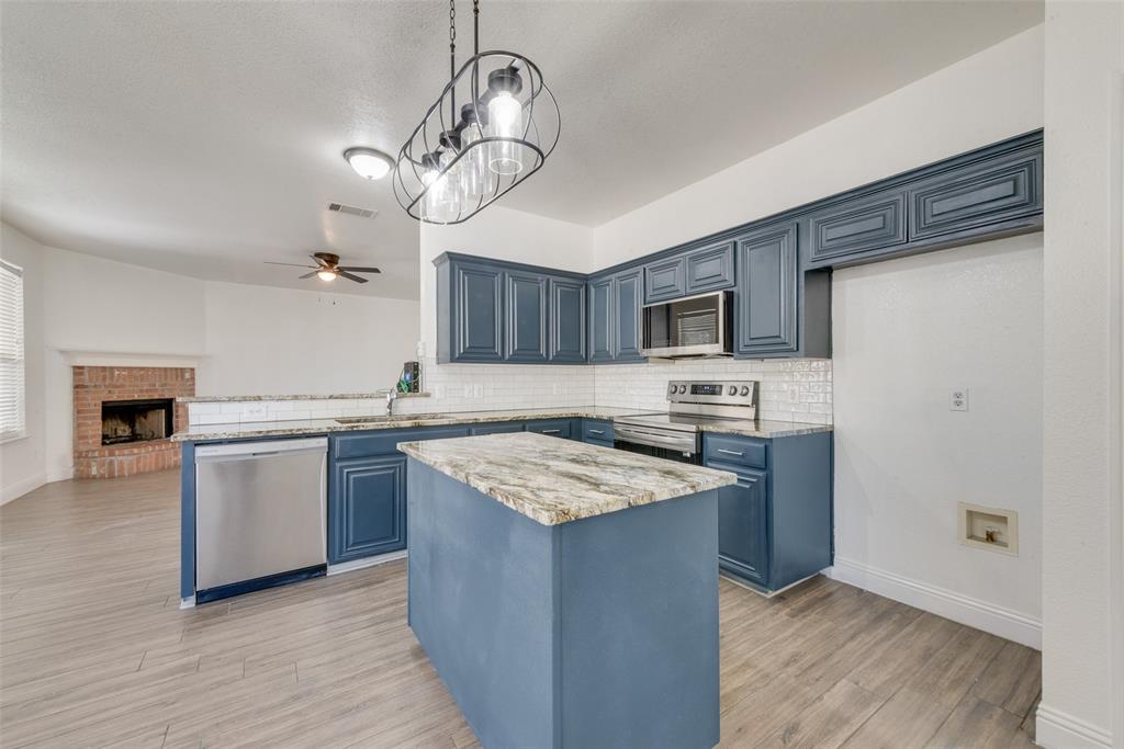 2701 Wildridge Court Fort Worth, TX 76108 - Photo 9 of 26 a kitchen with a stove sink and cabinets