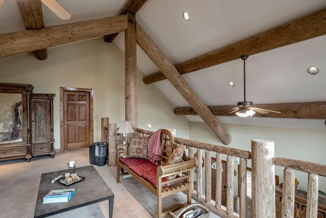 a living room with lots of furniture and ceiling fan