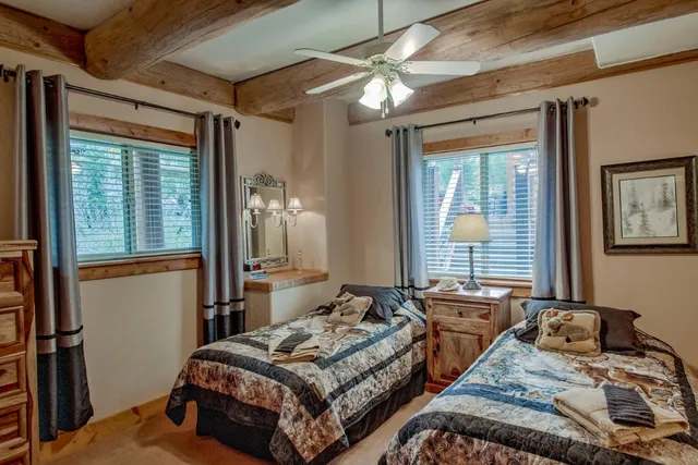 a bedroom with two beds and a window