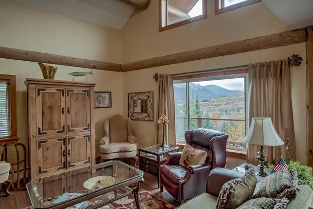 a living room with furniture a window and a flat screen tv